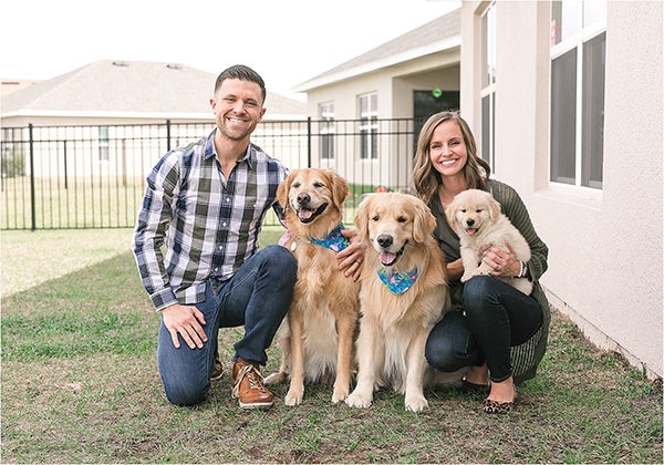 family successfully introducing new puppy to their dogs